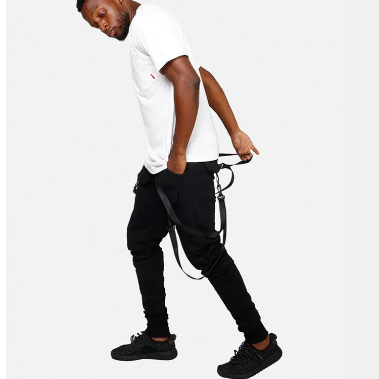 Black cotton blend men's hip hop pencil sweatpants with belt lying flat