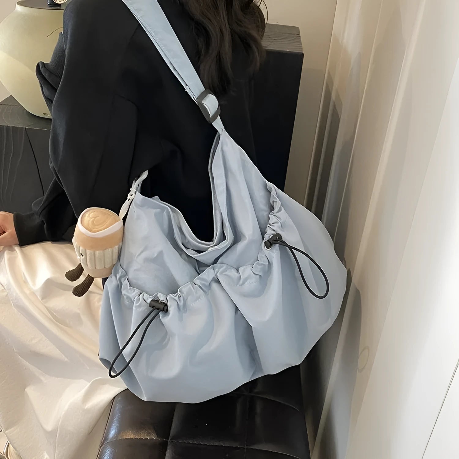 Green pleated crossbody student bag showing foldable polyester construction and internal mobile phone pocket