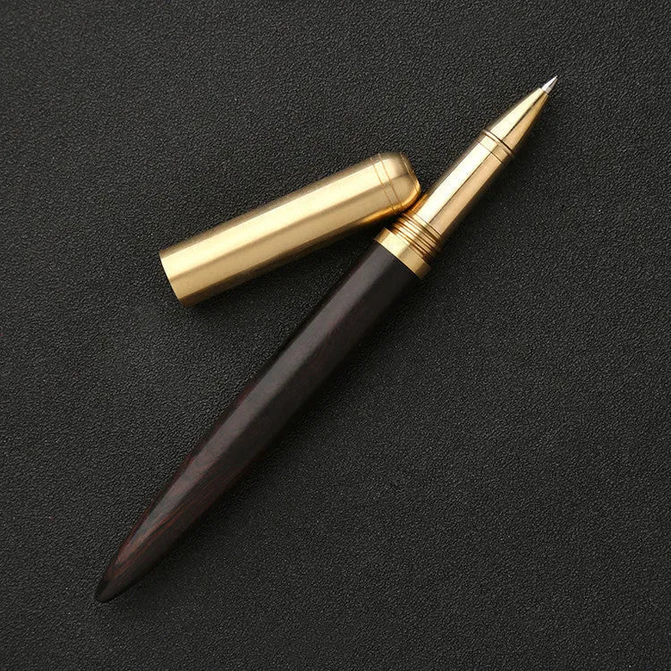 Brass and sandalwood solid wood signature pen with wooden barrel and brass fittings on a desk