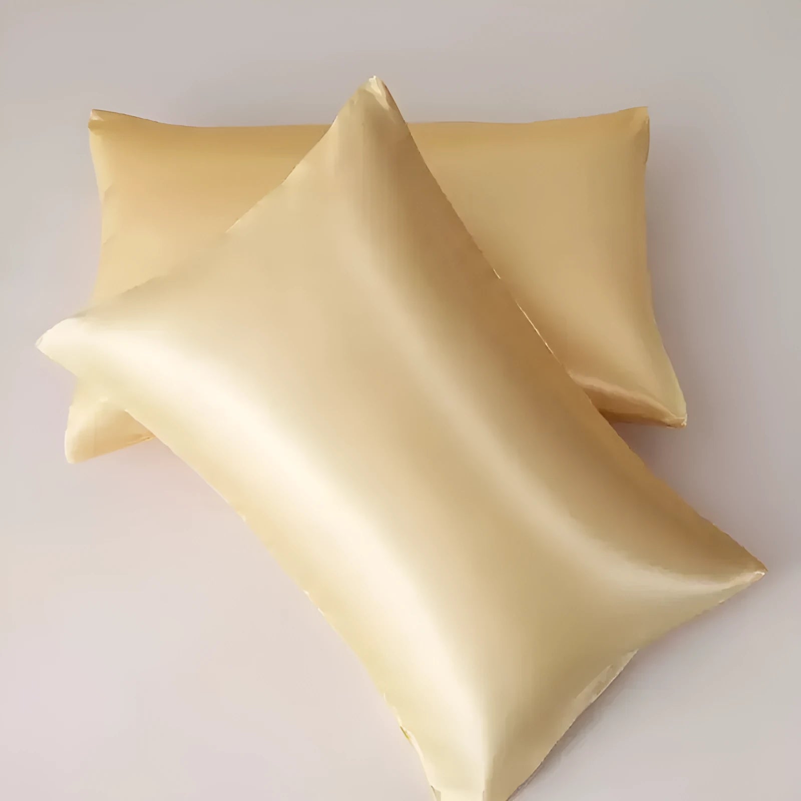 Pair of solid colour satin cloth pillowcases showing colour options including navy blue, wine red and light pink