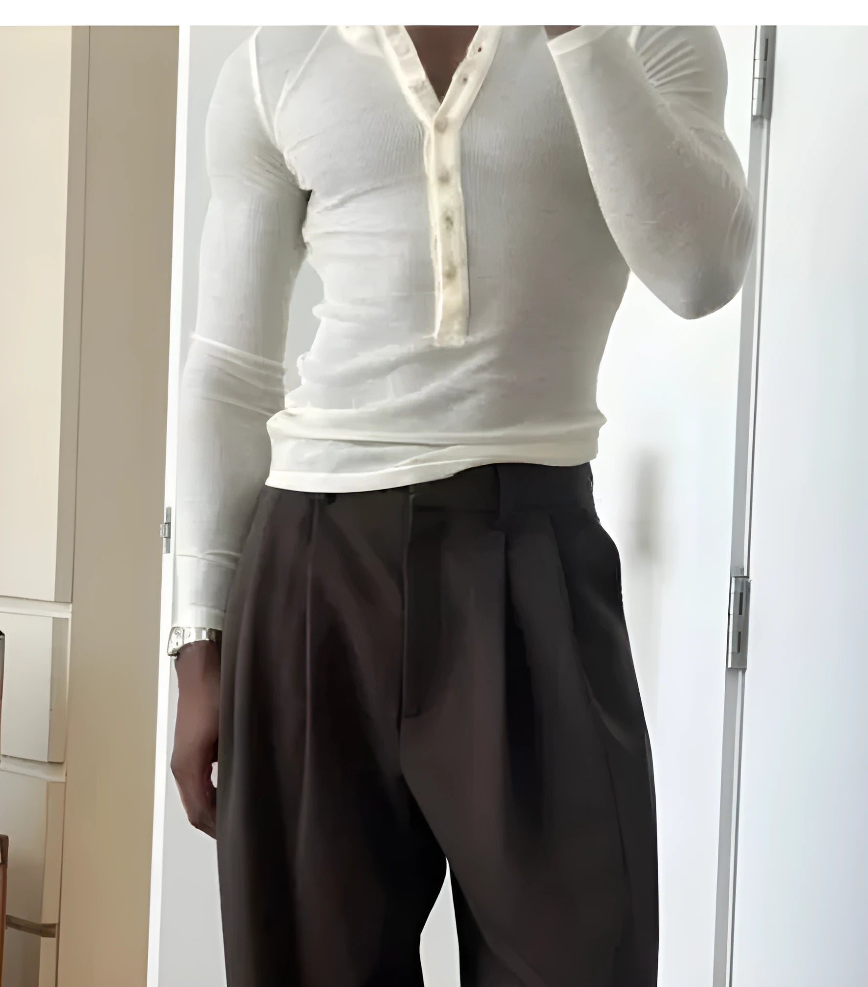 Man wearing cream-coloured ribbed long-sleeve henley top with four-button placket