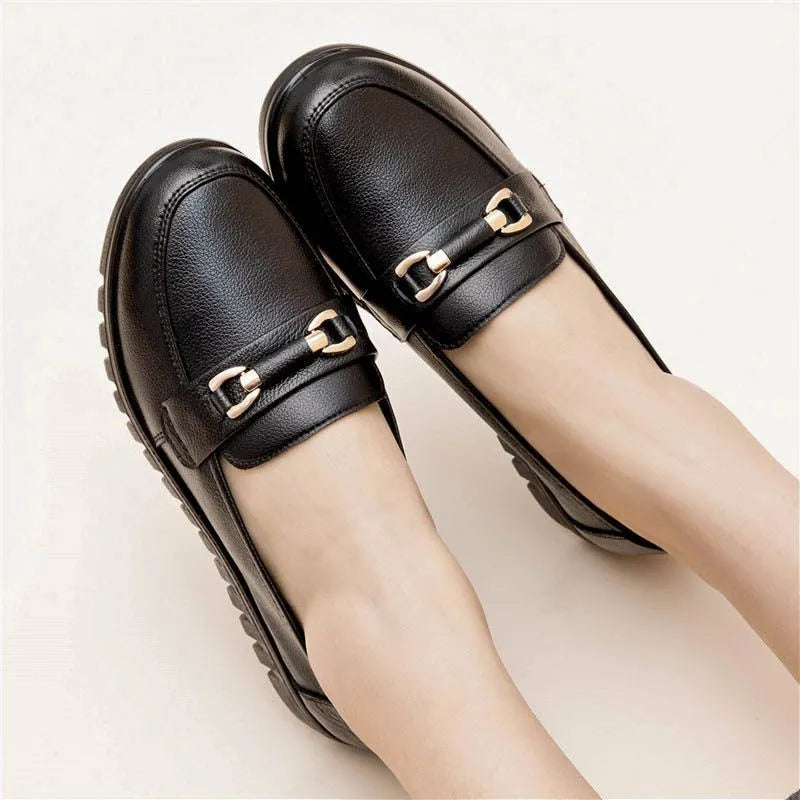 Black soft leather casual pumps with a round toe, flat rubber sole, and shallow slip-on design.