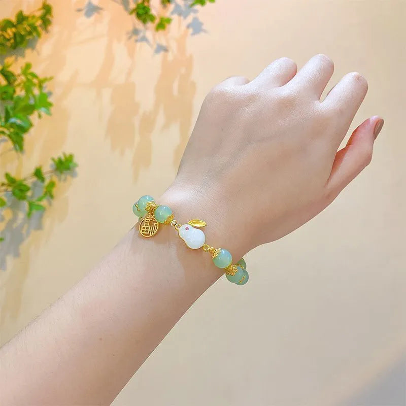 Chinese style glass bracelet with bamboo joint details in a red Lvzhu Duobao design.