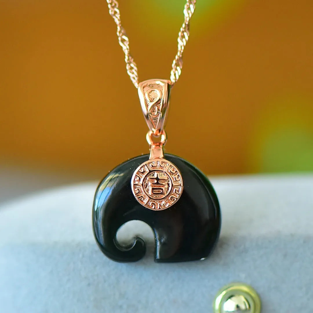 Copper inlaid natural Hetian gray and ink blue jade pendant necklace on a chain.