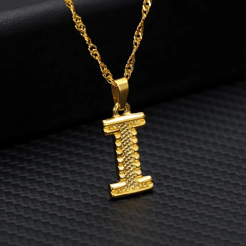 Gold-plated alloy initial pendant necklace with 42cm chain on white background