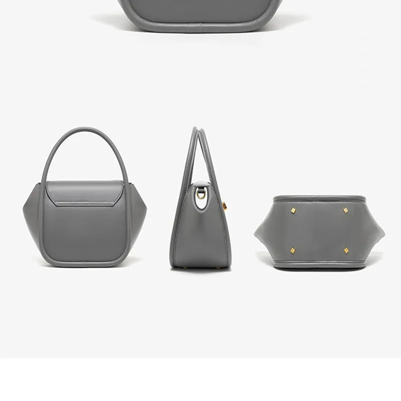 Women's leather wing-shaped tote bag with buckle closure in blue, grey, black, or brown colour options