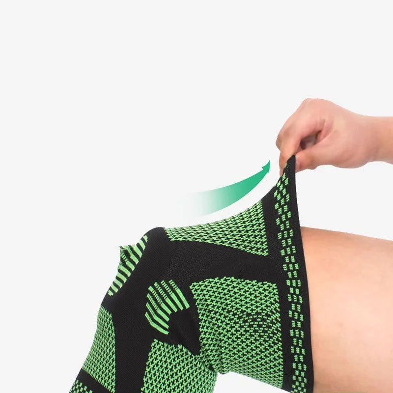 Green silicone spring knee pad for sports, showing polyamide construction and non-slip design on a leg.