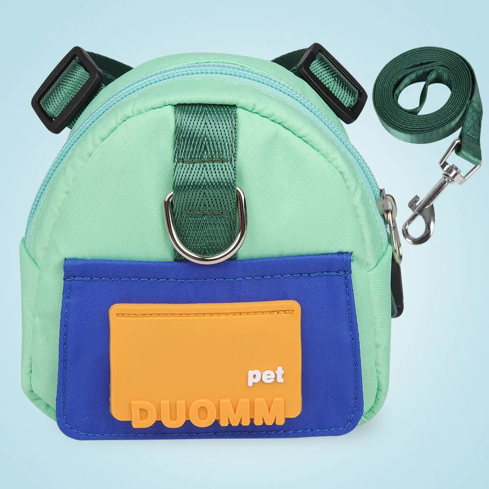 Blue adjustable dog backpack harness with storage compartment and a tow rope laid flat