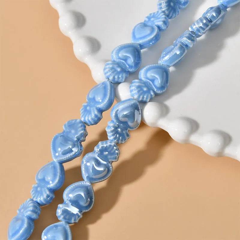 Ceramic heart torch beads in various colours for jewellery making, approximately 10mm by 15mm with straight hole