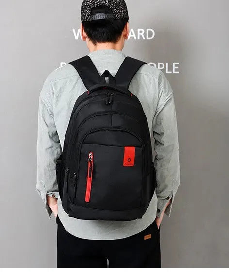 Blue lightweight Oxford fabric backpack for teenagers with side zip pockets and padded straps.