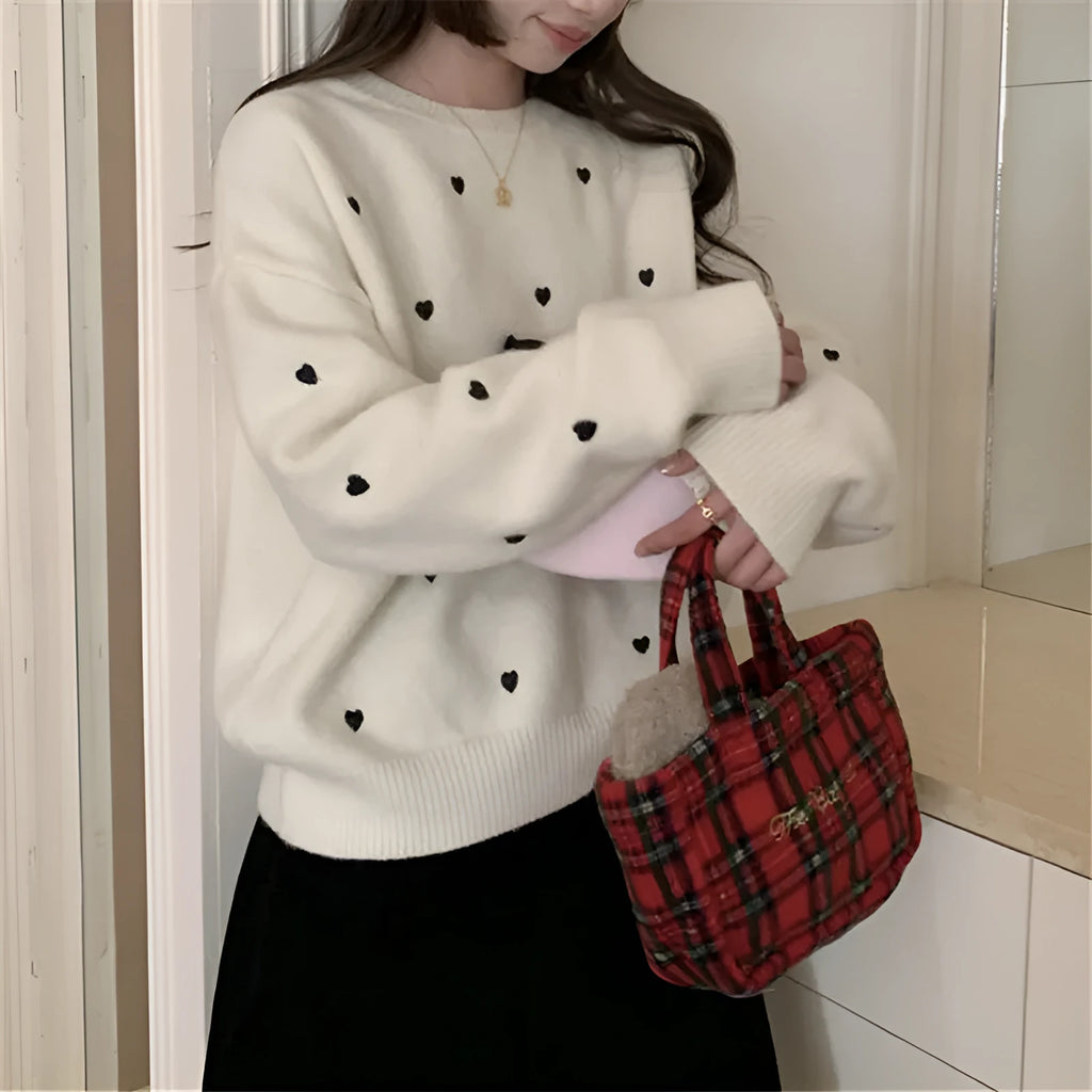Women's loose-fit acrylic pullover sweater with embroidered heart detail on the front.