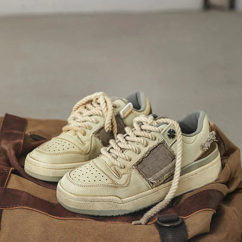 Beige vintage patch skateboard shoes with lace-up closure and low-top design