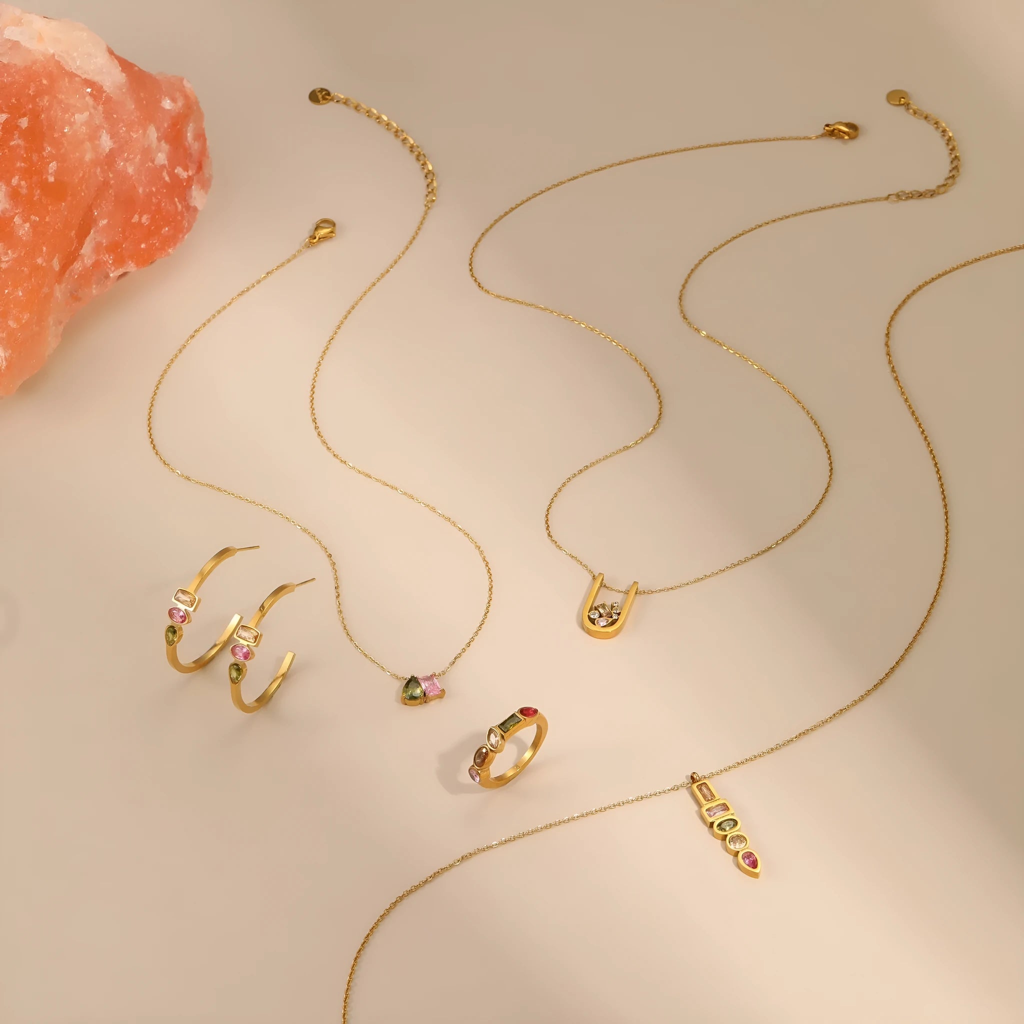 Geometric gold-plated jewellery set with necklace, earrings, and ring on display