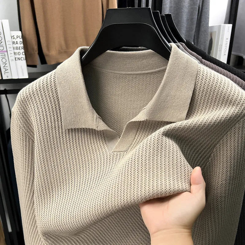 Man wearing a loose-fit camel-coloured pullover sweater, a simple casual knit for autumn.
