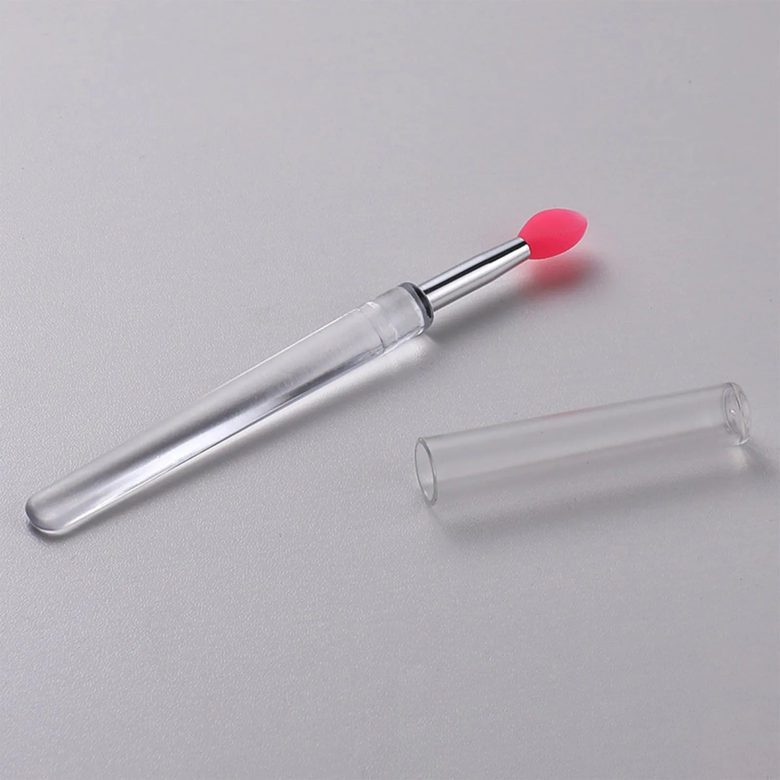 Set of reusable silicone lip brushes with protective caps in various colours.