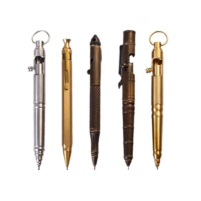 Close-up of a solid brass bolt action tactical pen with a press mechanism on a dark surface.