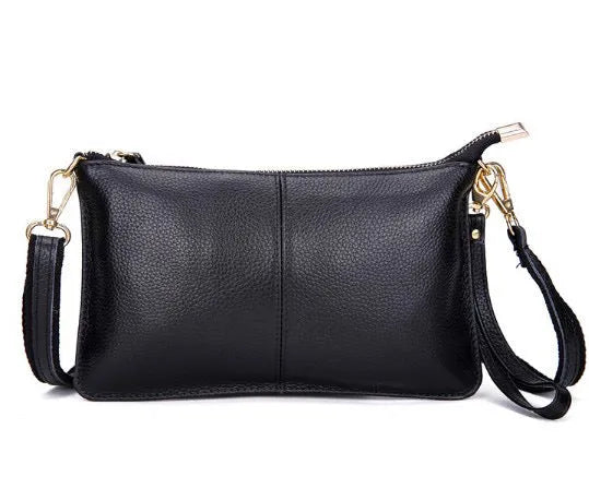 Structured cowhide lady slant bag in apricot colour with hand strap and shoulder strap, showing slim profile.