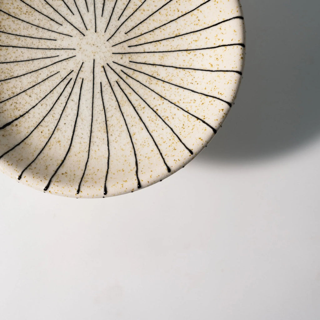 Black and white striped synthetic resin fruit plate or dessert plate on a table
