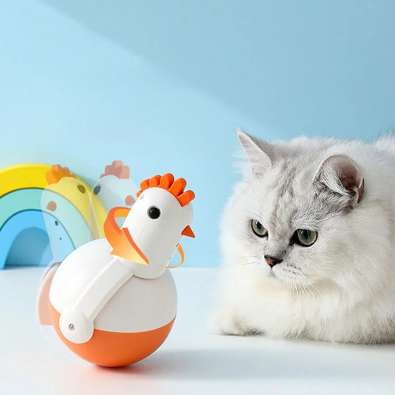 Green or orange electric cat toy chicken with laser and sound features on flat surface