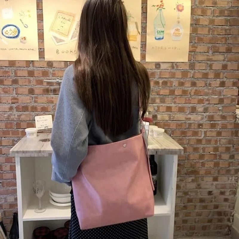 Pink corduroy one-shoulder commuter bag with dimensions 39cm by 32cm