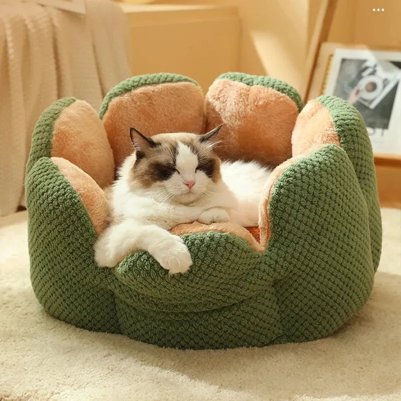 Green cactus petal shaped enclosed soft plush bed for a cat or small dog on a hardwood floor.