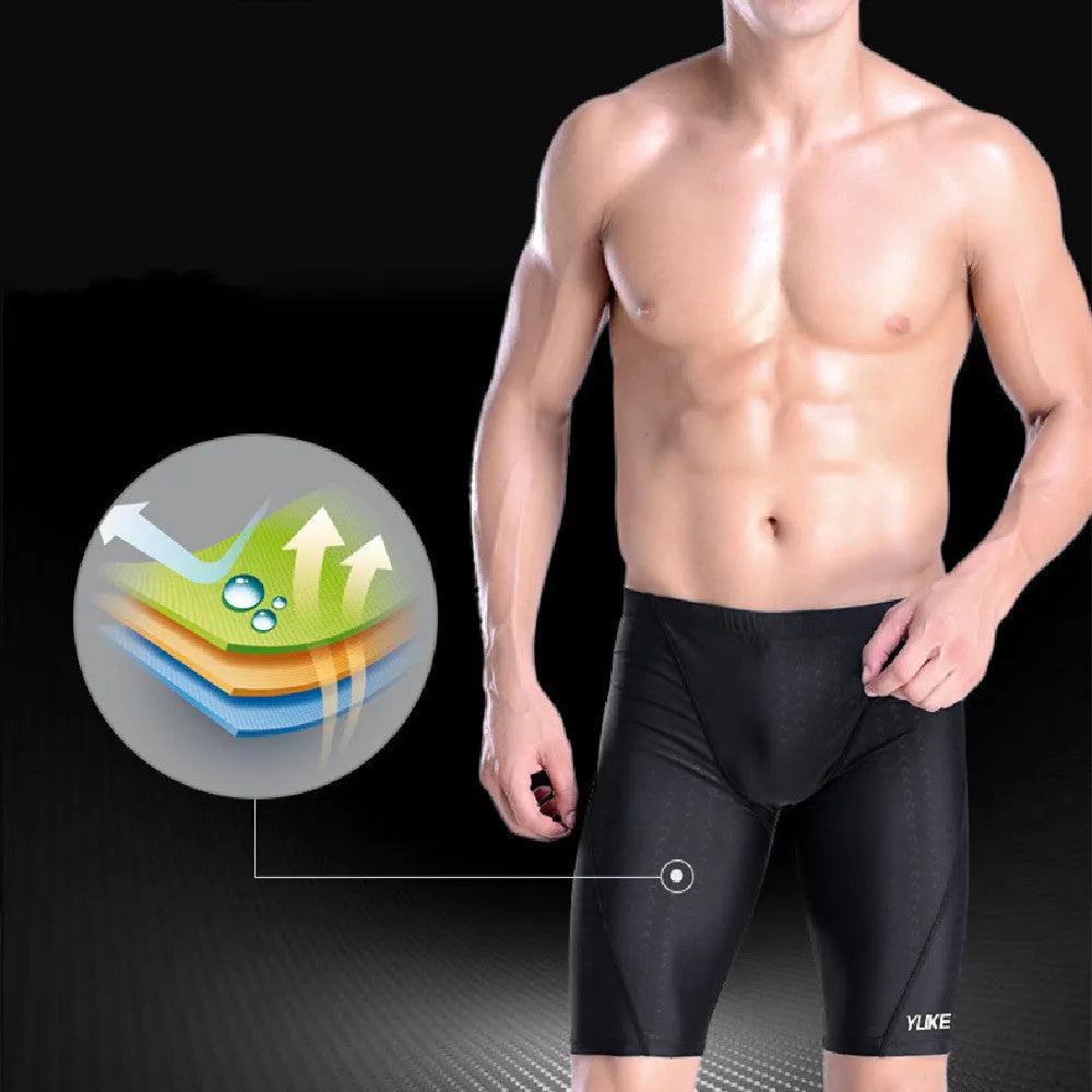 Men's black five-piece swimming set including trunks, goggles, cap, ear plugs, nose clip, and carry bag laid out flat.