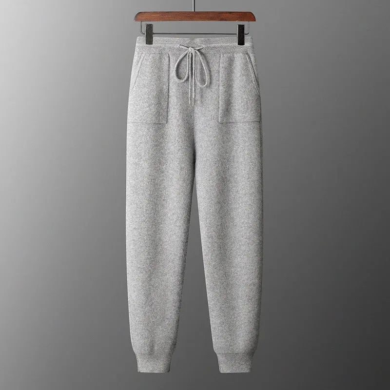 Men's light grey cashmere hooded sweatshirt and matching long pants set laid flat.