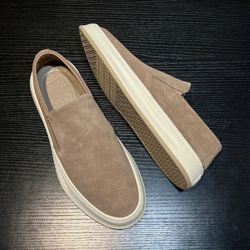 Men's grey slip-on casual shoes with round toe design and visible stitching details