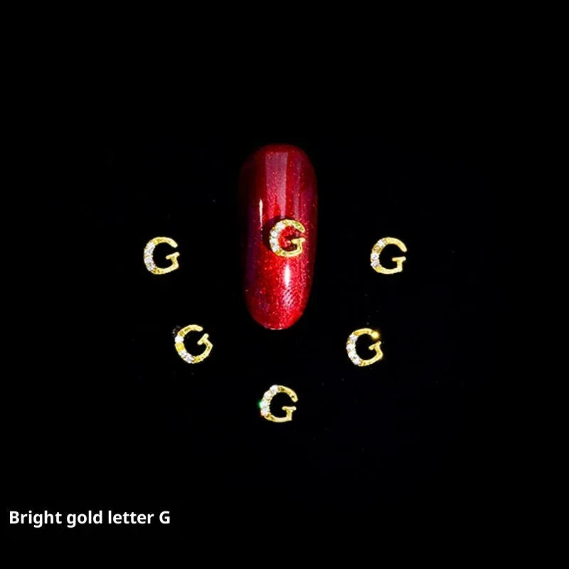 Gold alloy letter A nail ornament charm with crystal detail on a square chain base