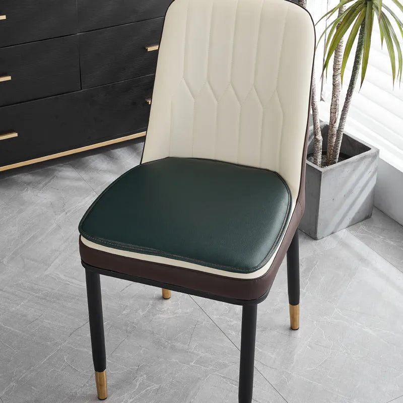 Leather horseshoe-shaped seat cushion in beige colour on a wooden chair, showing non-slip base