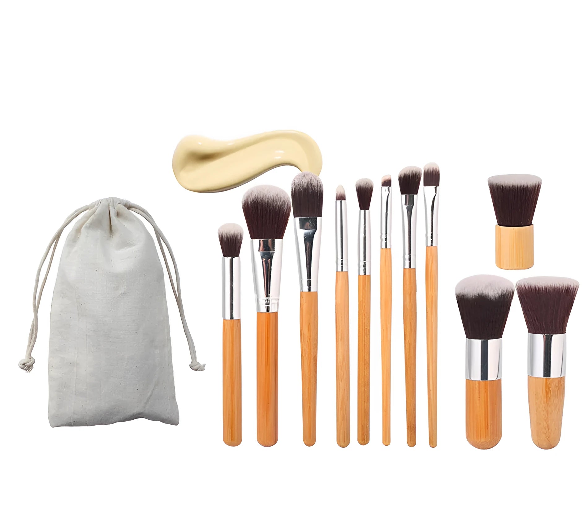 11 bamboo handle makeup brushes arranged on linen bag, including foundation blush and eye shadow brushes