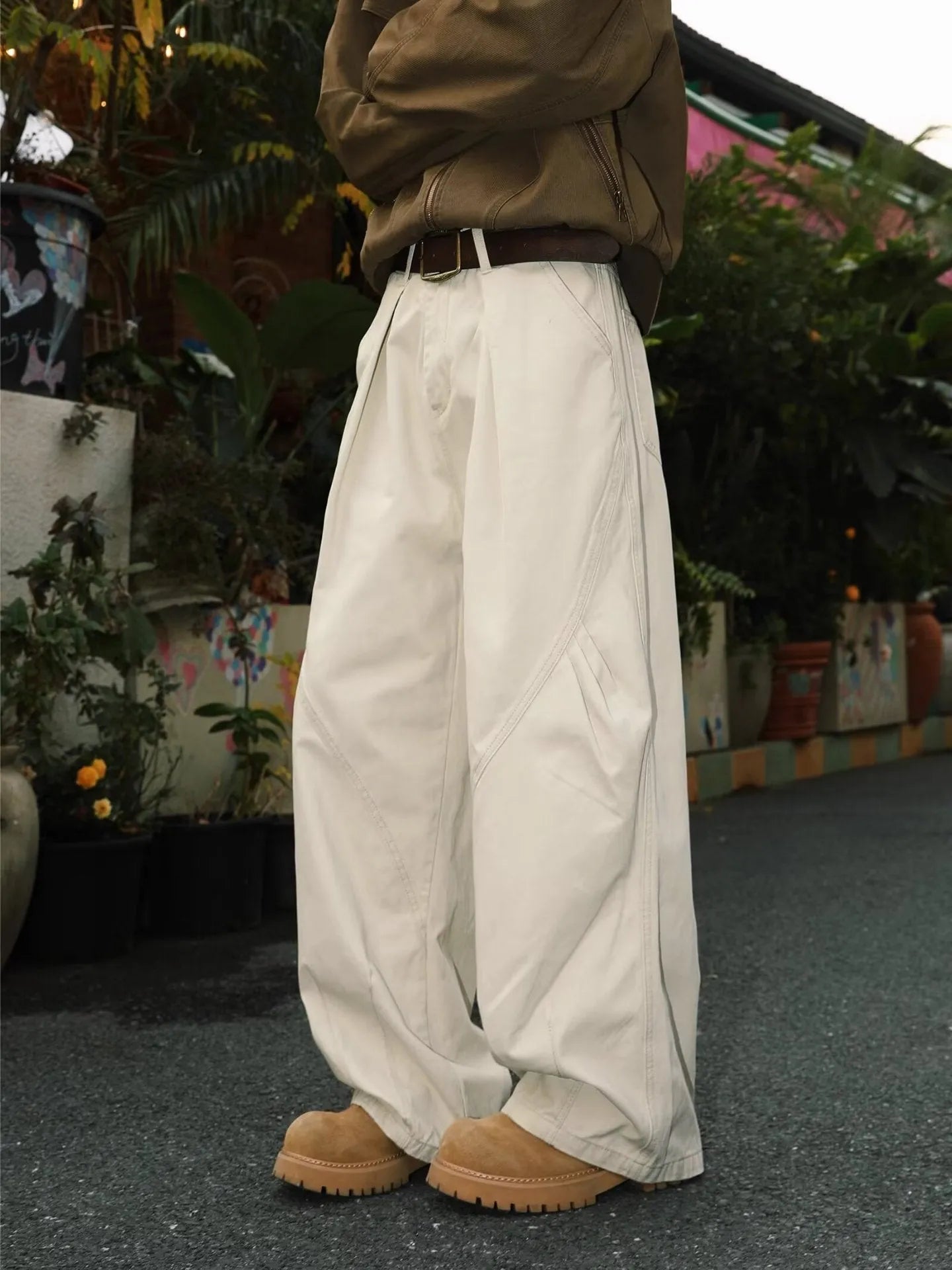 Men's pleated straight loose trousers in black striped pattern showing straight leg design