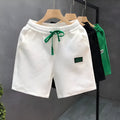 Casual polyester sports shorts with micro elasticity in black, white or green colours