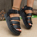 Black thick-soled casual sandals with an adjustable strap buckle on a white background.