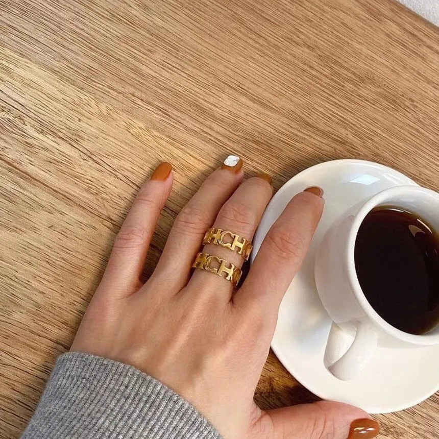 Gold titanium steel hollowed cut letter ring in unisex geometric Korean style, sizes 6-9