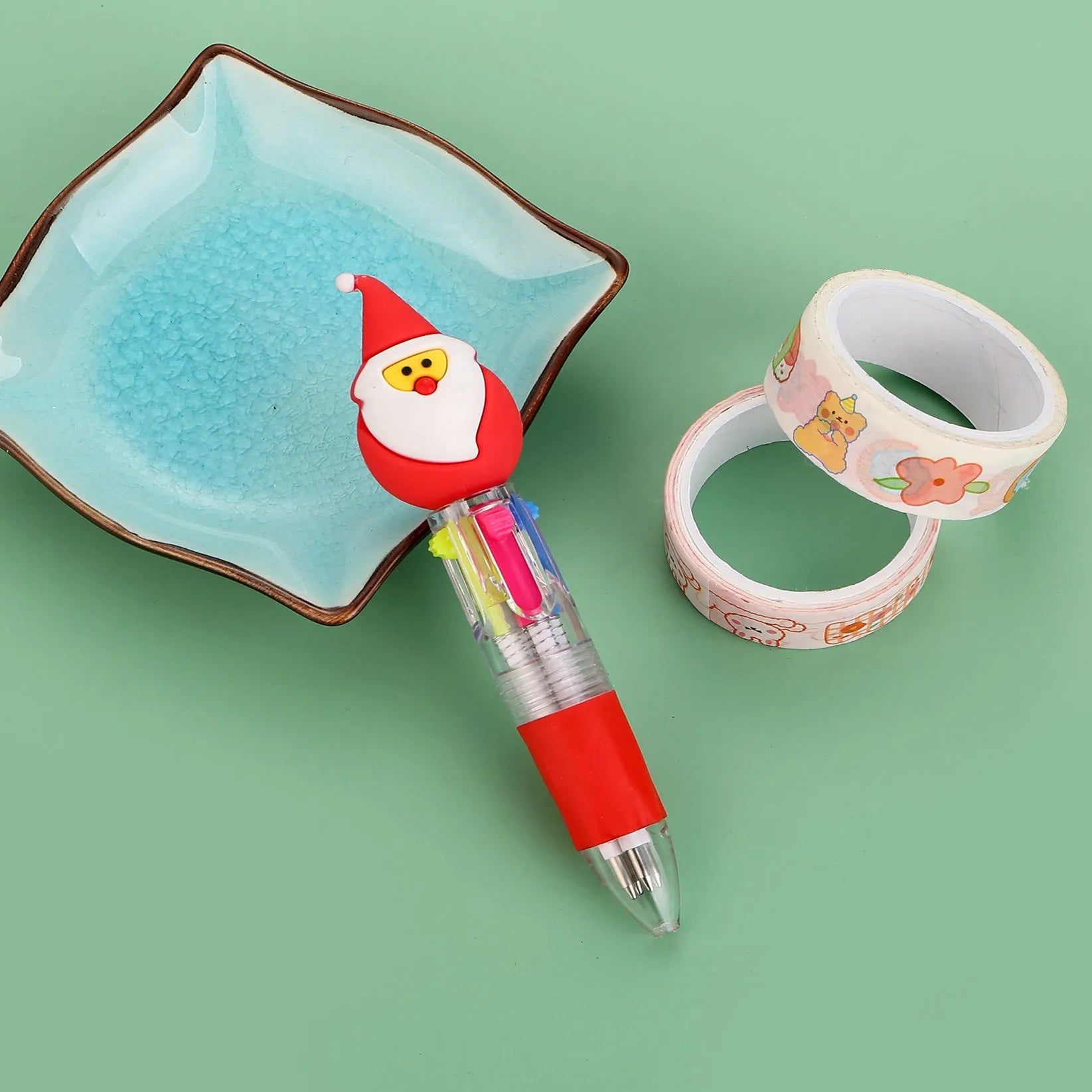 Compact 11cm Christmas-themed press-action ballpoint pen with festive designs.