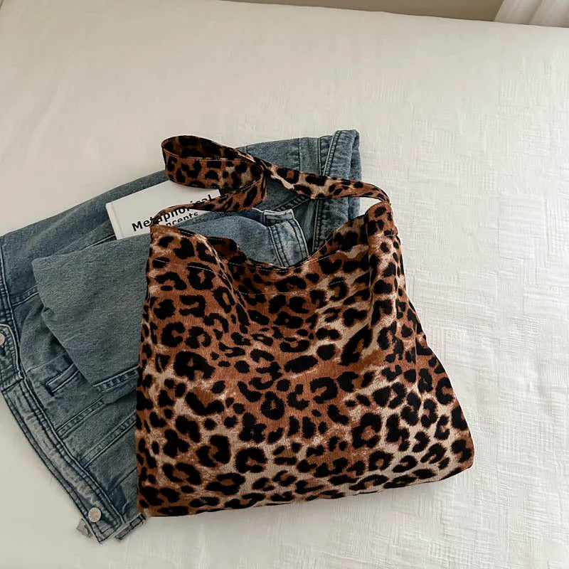 Leopard print shoulder messenger bag with square vertical shape and single strap, available in black, brown, and pink