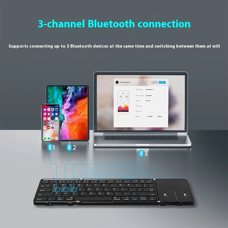 Black folding Bluetooth keyboard with touchpad option next to a mobile phone