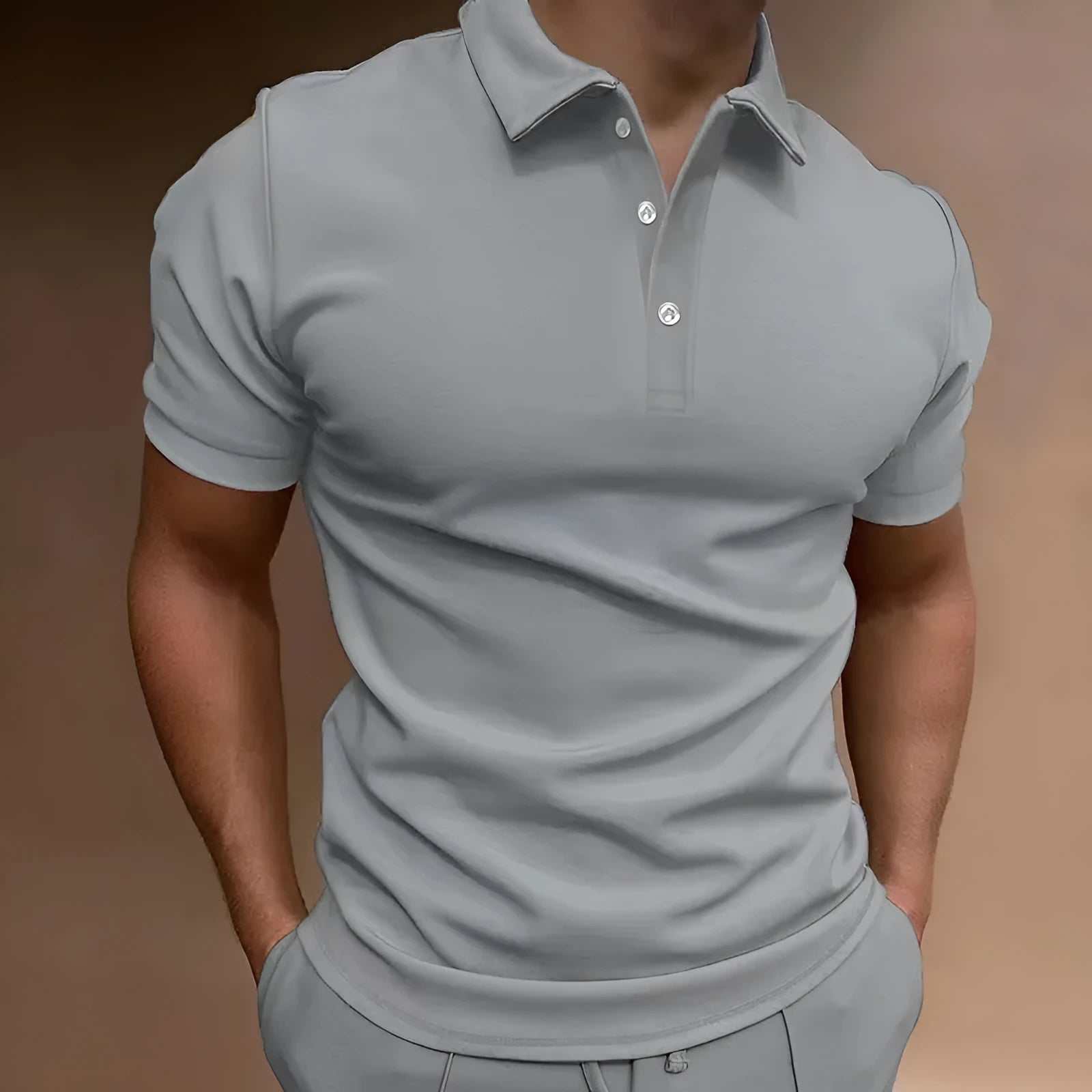 Man wearing a loose fit grey cotton blend T-shirt with a button-down front and short sleeves.