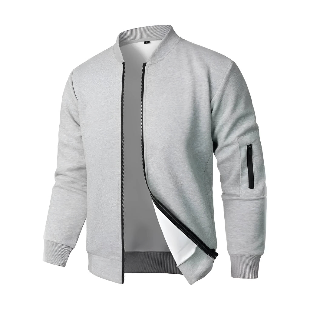 A man wearing a loose-fit grey cotton knitted jacket with long sleeves.