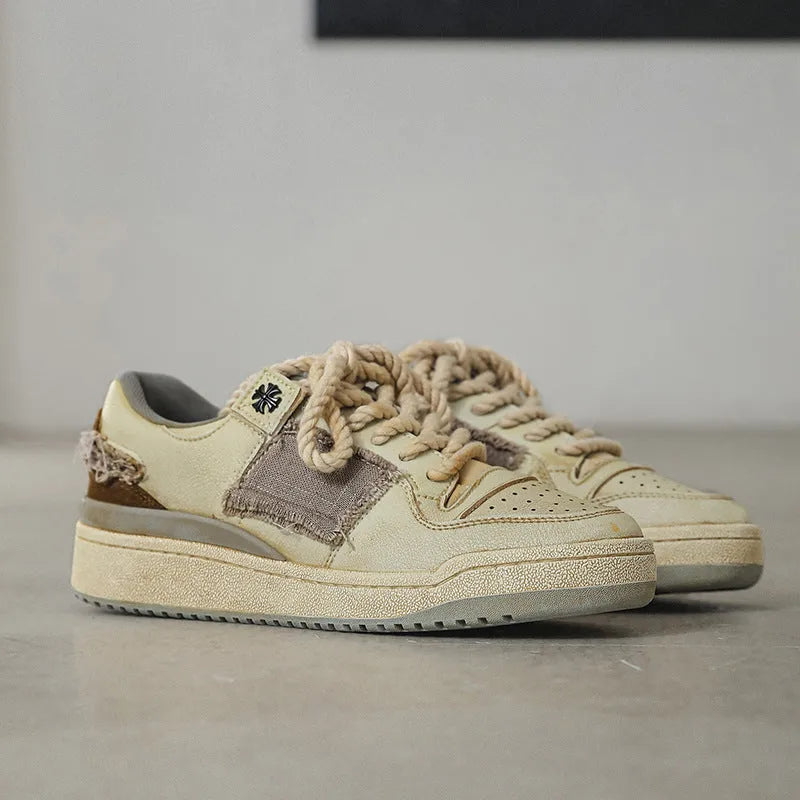 Beige vintage patch skateboard shoes with lace-up closure and low-top design