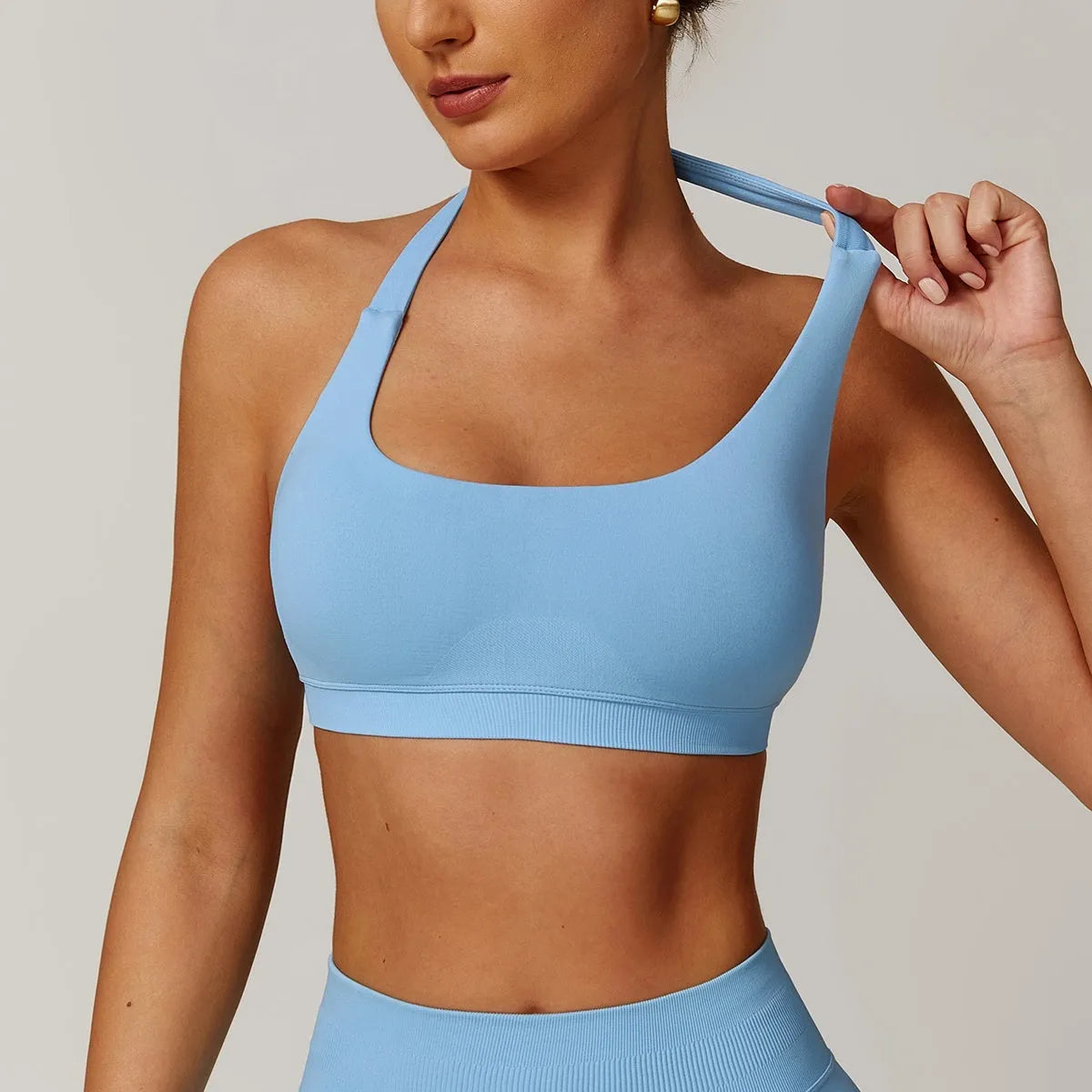 Halter neck sports bra for women in multiple colours with medium support and built-in chest pads