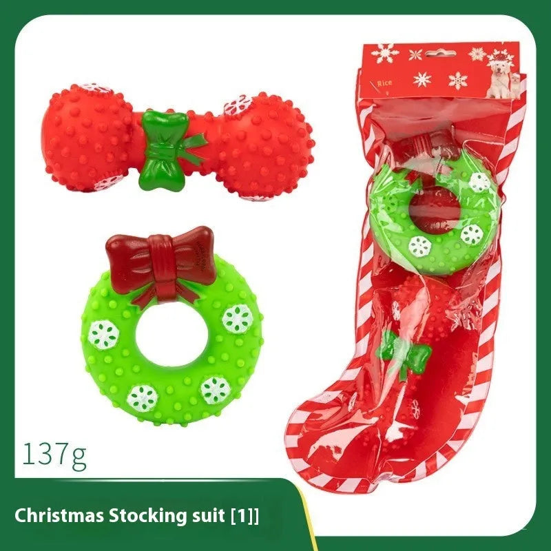 Christmas-themed vinyl dog toys including barbell, ball, rope, and Santa designs in gift packaging