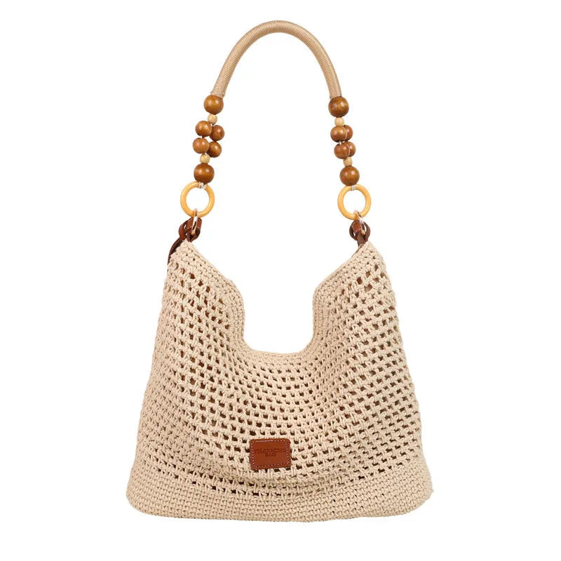 Knitted tote beach bag with contrast stitching showing crossbody strap and zip compartment