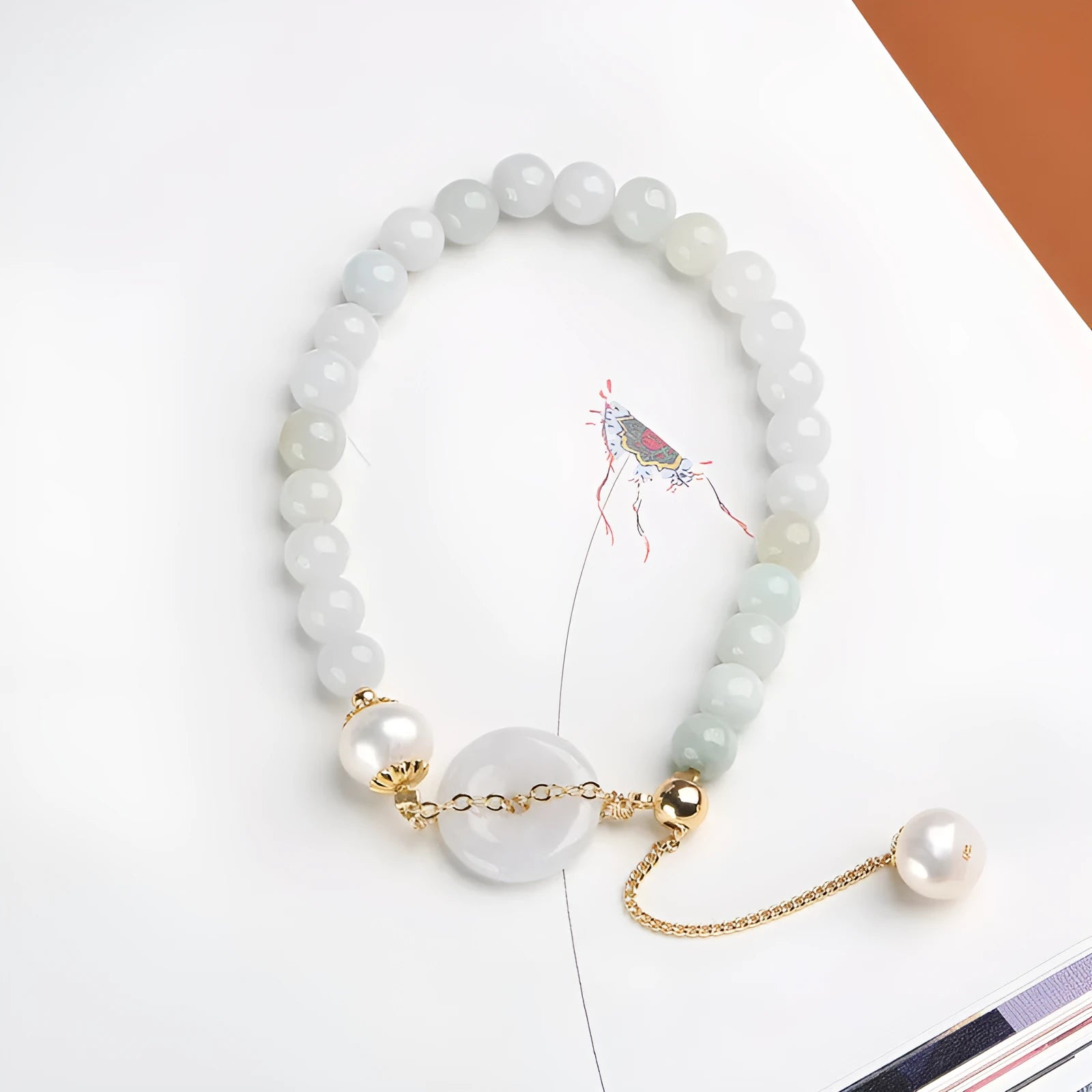 Natural emerald peace buckle pearl bracelet for women with jade round pendant on a geometric design.