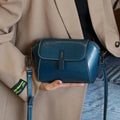 Women's brown oil wax leather messenger bag with cross-body strap and multiple internal compartments