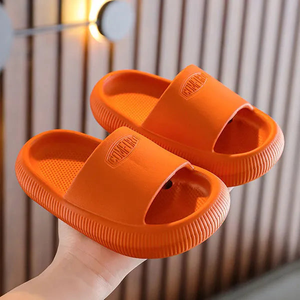 Children's bright coloured EVA slippers with non-slip soles in blue, green, orange, pink, and yellow.