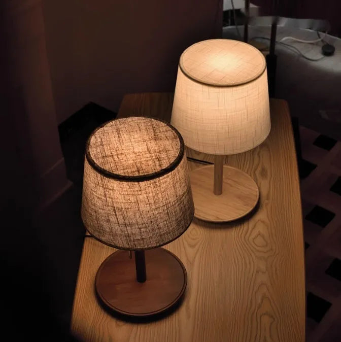 Walnut-coloured solid wood bedside lamp with fabric shade and cable switch