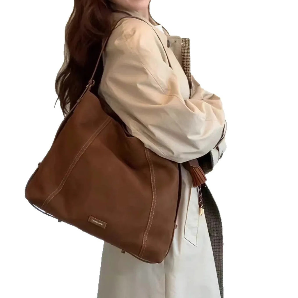 Large capacity soft suede messenger bag in coffee colour with single shoulder strap and sewing line detail