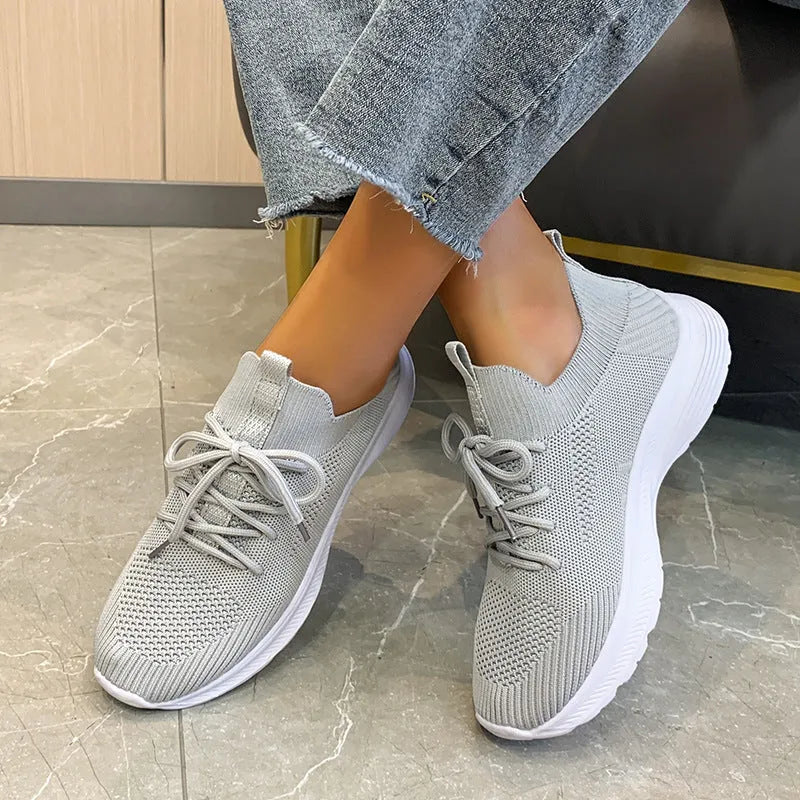 Women's Flyknit running shoes in Creamy White with mesh lining and rubber sole